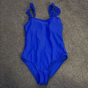 One piece suit with open back and sheer skirt cover up